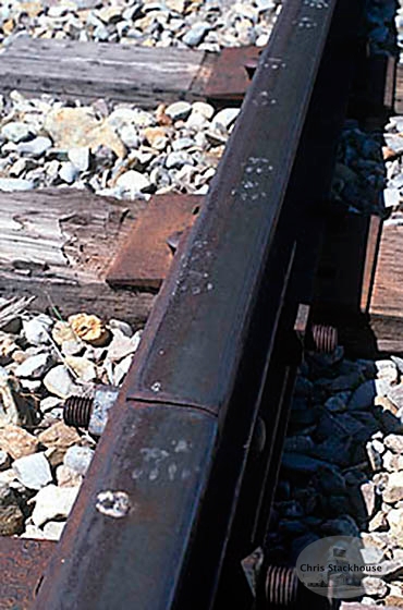 "Tracks" Footprints on top of a steel rail.